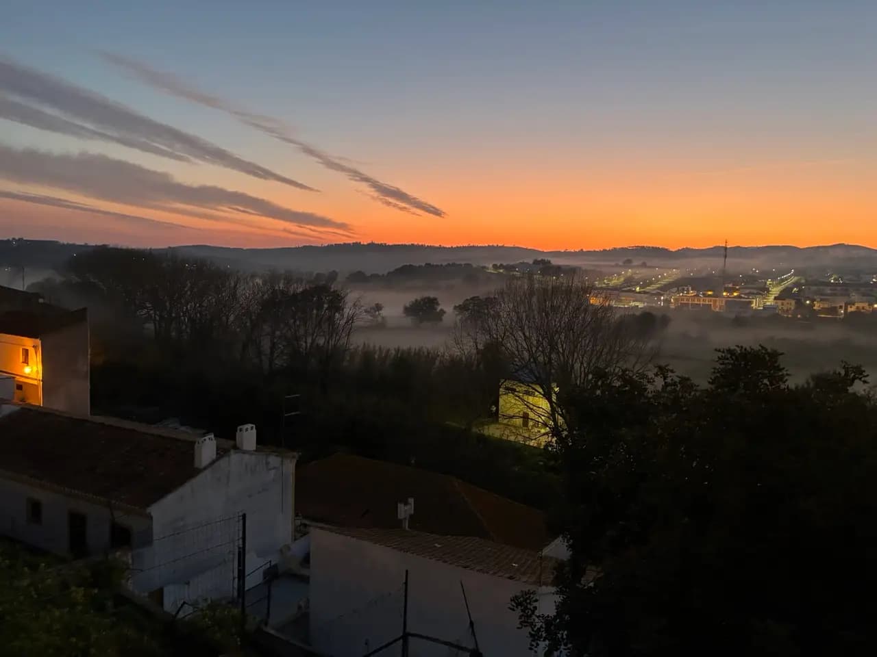 Early morning sunrise over Aljezur with mist rolling through the valley