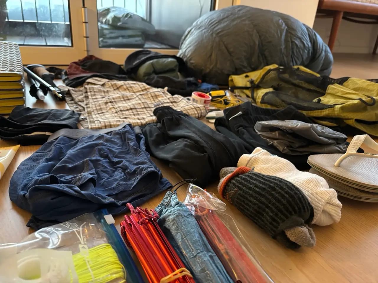 Close-up of a packed hiking backpack and gear laid out for the Fishermen's Trail