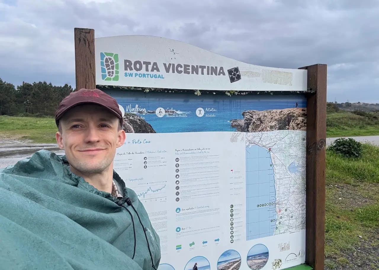 Hiker wearing a rain poncho on the Fishermen's Trail coast