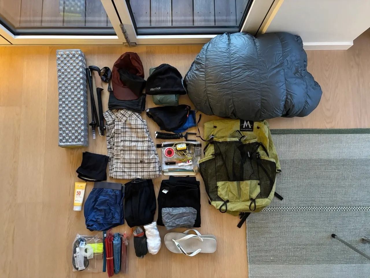 Flat lay of Fishermen's Trail gear including backpack, shoes and clothing
