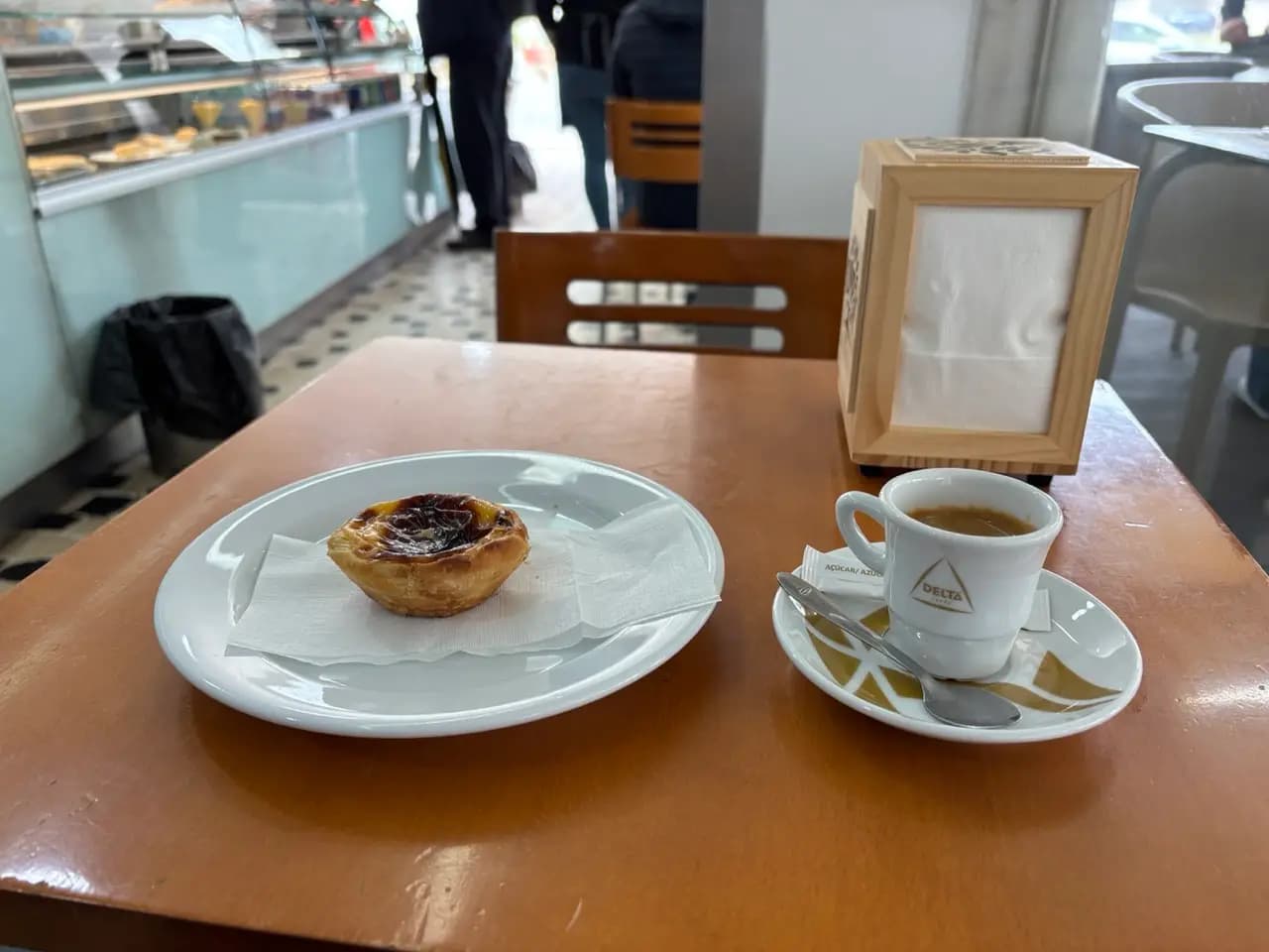 Pastel de nata custard tart and espresso on a café table Pastel de nata custard tart and espresso on a café table